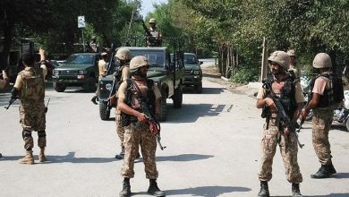 Pakistani soldiers cordon off a street leading to Christian colony following an attack by suicide bombers on the outskirts of Peshawar on September 2, 2016.
